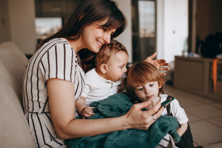 Smiling Woman Sitting with Sons